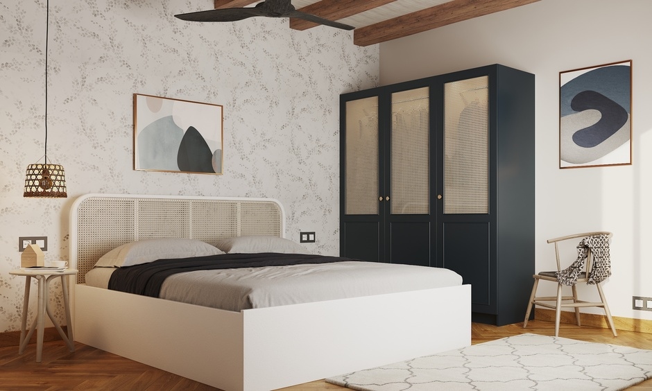 Navy blue wardrobe with cane shutters in a Mumbai bedroom, blending eco-friendly design with modern aesthetics