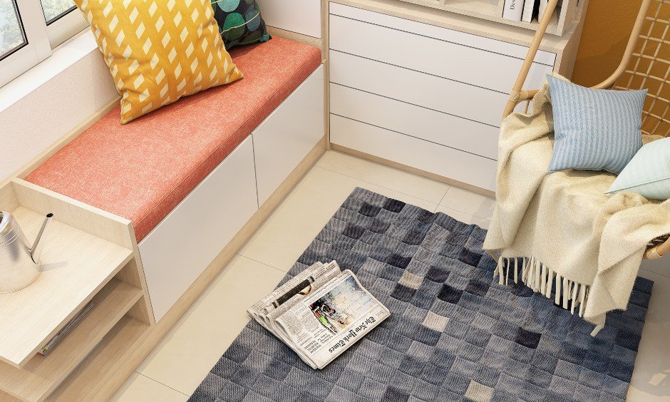 Balcony design for Indian homes with a low-lying seating arrangement with storage