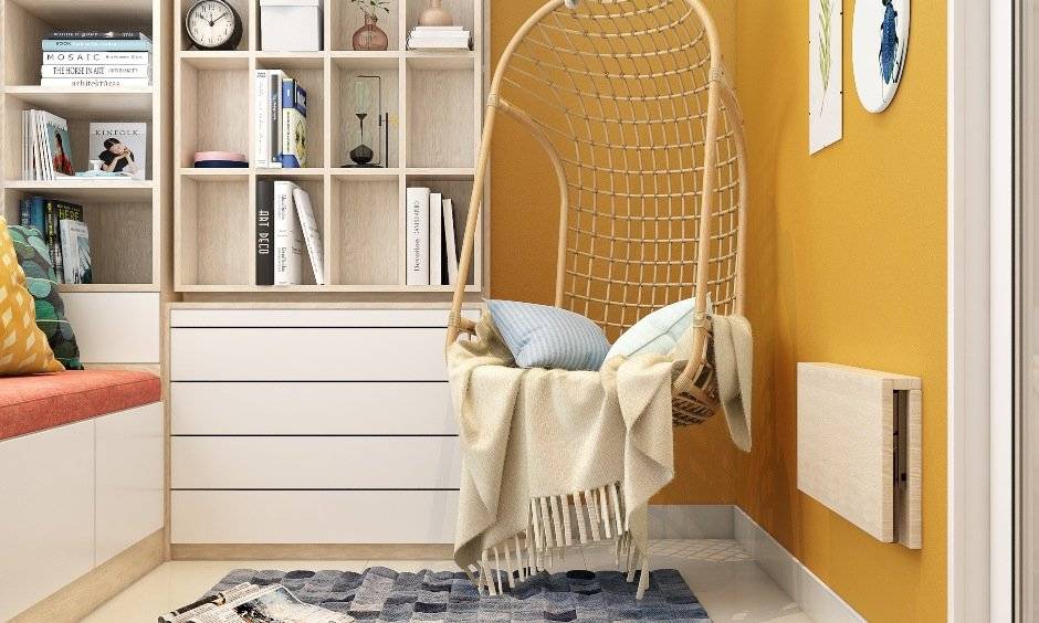 Balcony interior design with wicker swing with cushions and a wall-mounted tabletop