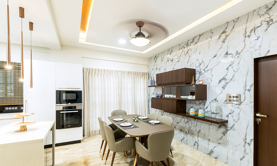Modern dining room with a rectangular false ceiling and recessed lighting, showcasing a sleek and minimalist design.
