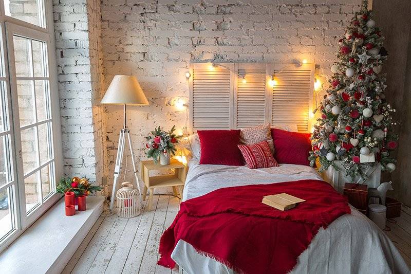 Christmas bedroom decoration with a bright red blanket for a festive vibe