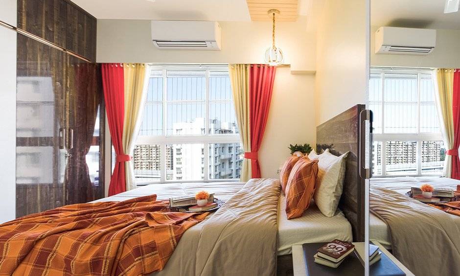 A bedroom with a wardrobe designed by one of the best residential interior designers in mumbai