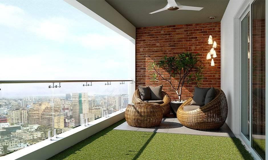 Clear glass balcony grill with bricked wall and artificial turf