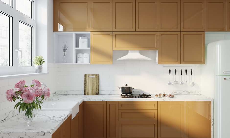 Elegant brown kitchen with white accents, marble countertops, and brass details for a timeless look