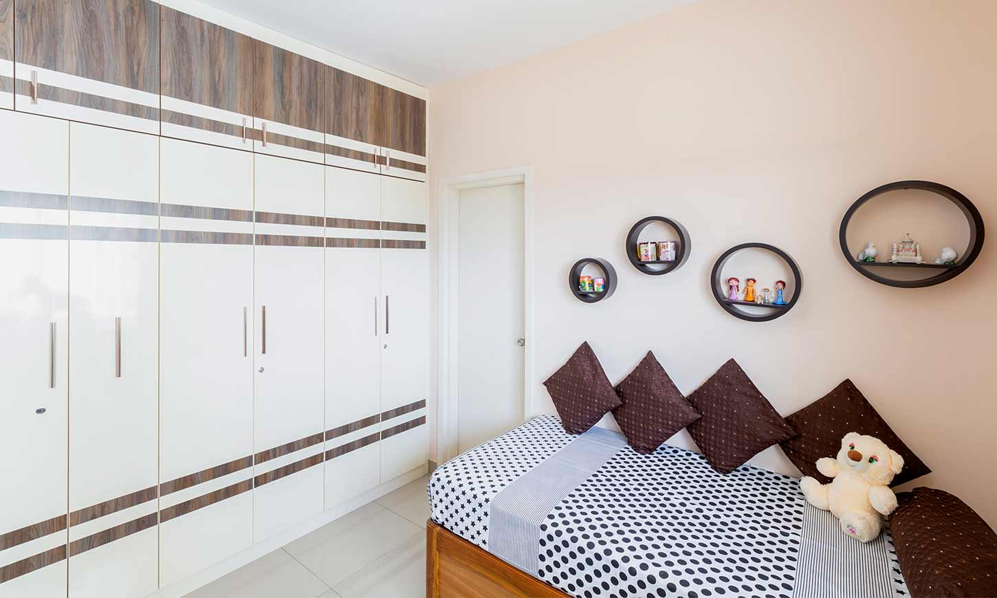 Bedroom with diwan and wardrobe designed by budget interiors bangalore