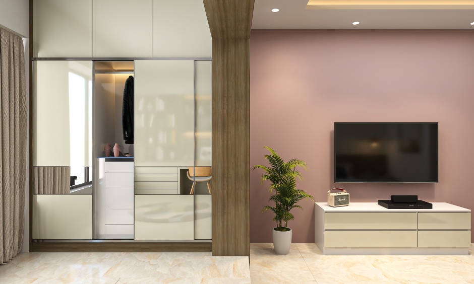 cove lights and spotlights on the false ceiling illuminates the living room in a 2bhk interior design