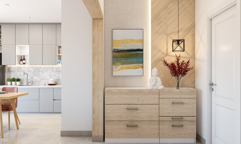 Entryway in 1 bhk house designed with a wooden foyer unit with multiple drawers matches the design scheme
