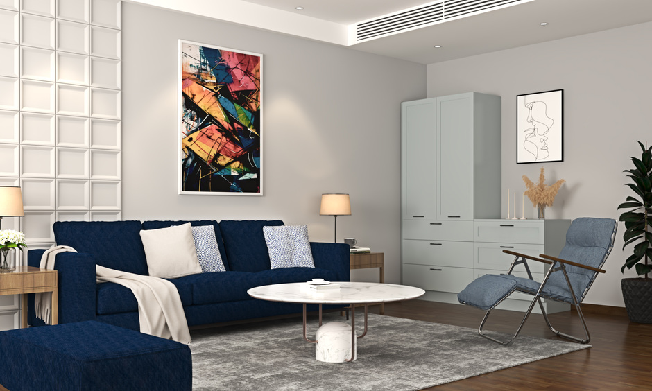 Soft blue folding recliner chair beside a royal blue sofa against grey walls, offering stylish comfort and space-saving design.