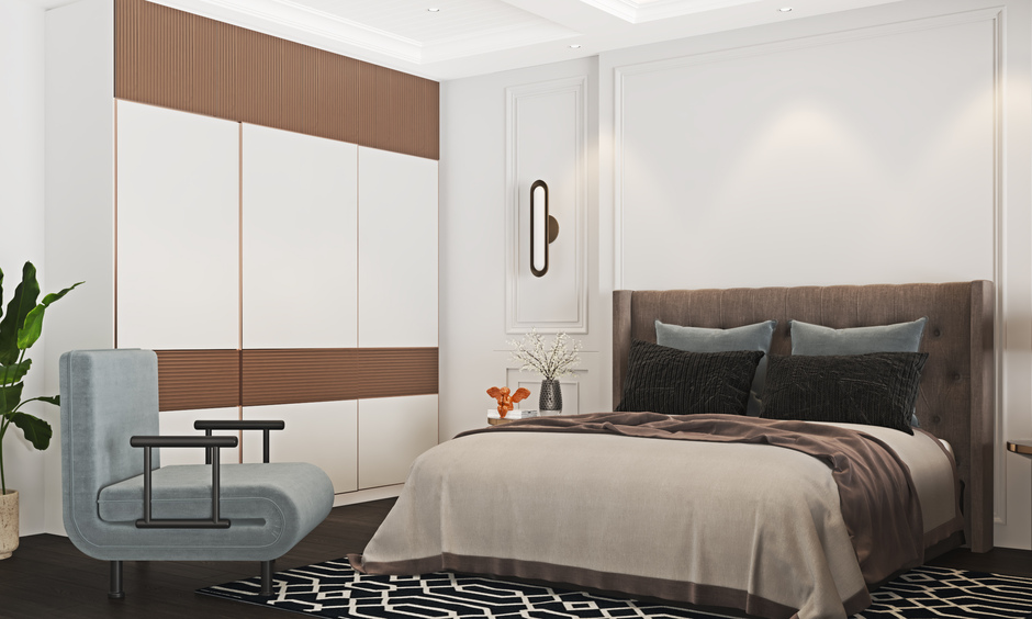 Folding sofa chair beside a double bed in a stylish guest room, offering comfort and space-saving convenience.