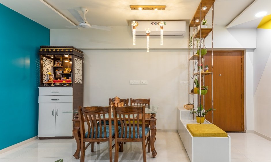 Interior design services in mumbai with traditional wooden dining table, a sleek pooja unit with storage space beneath