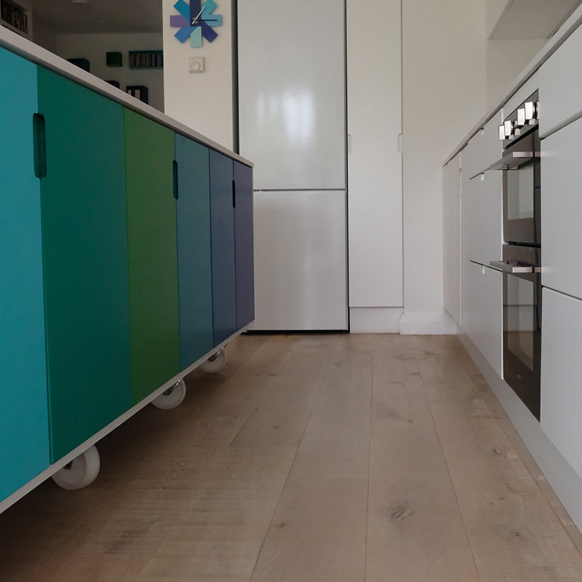 Kitchen island is finished retro style with the mdf doors painted such that the blues merging with the greens