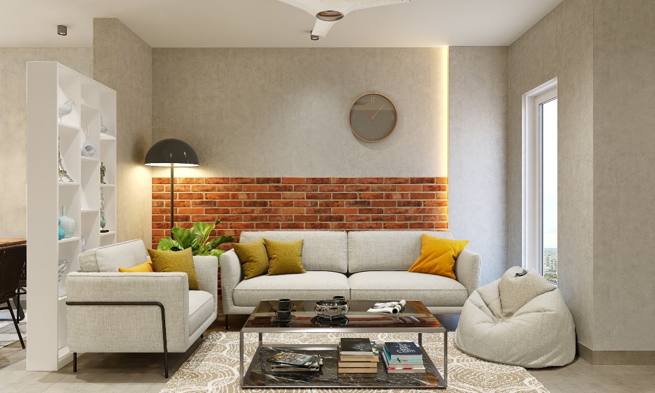 Living room home interior for 1bhk flat is designed in sandstone wallpaper and brick cladding wall; the sofa unit and a bean bag