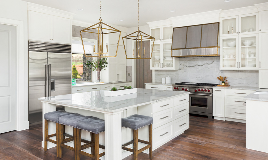 Luxury modern white kitchen with elegant cabinets, marble countertops, and stylish pendant lights