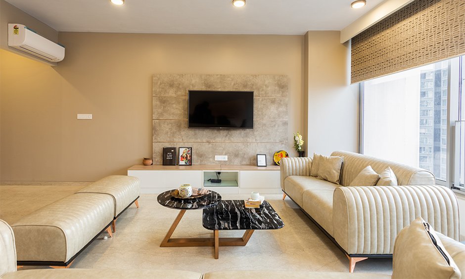 Entertainment unit designed with a marble backpanel and a TV screen by affordable interior designers in mumbai