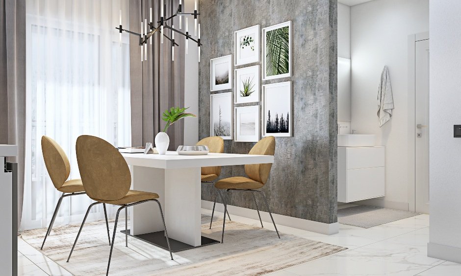 Dining area has a white dining table and four armless chairs in 3bhk flat interior design