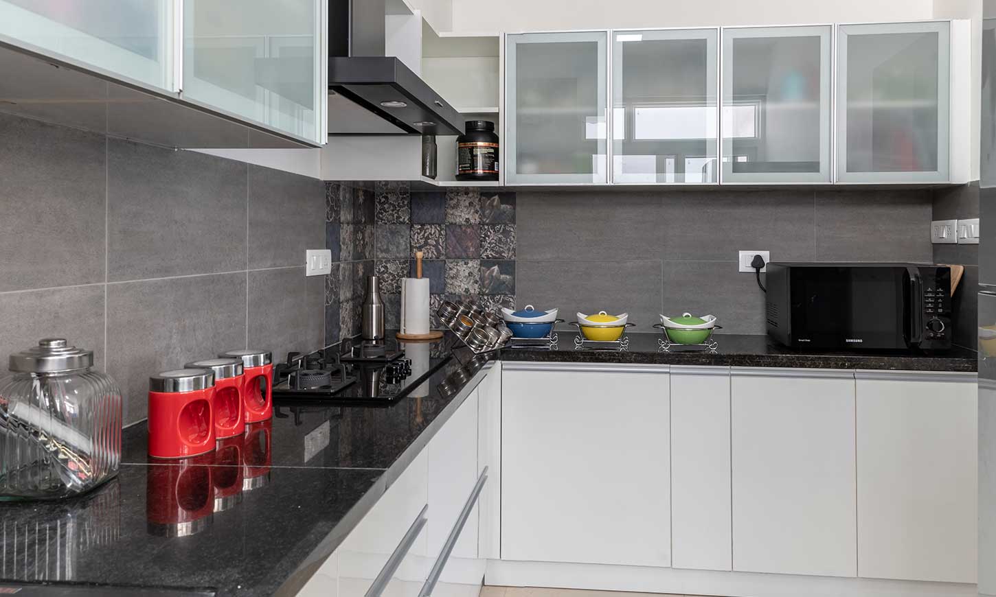 Modular kitchen bangalore with duco finish cabinets and granite countertop by interiors bangalore