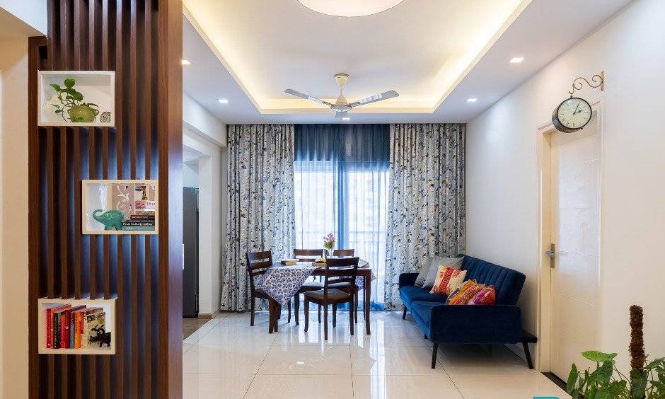 Open dining room with a wooden partition in 2bhk house, Tejaswini Nagar