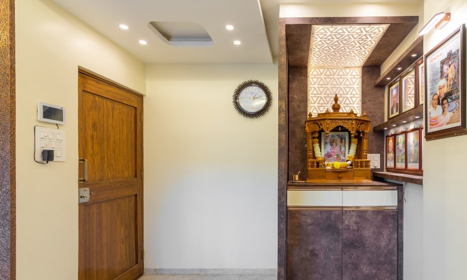 Glossy cream and matte brown finish pooja unit in 2bhk home design