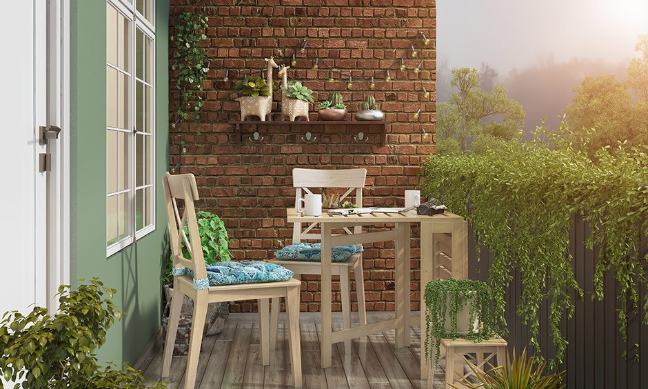 Small balcony design having a small table with comfortable chairs