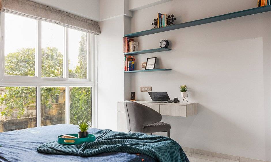 Top interior designers in mumbai where the third bedroom has a gorgeous, well-lit design with a simple, wall-mounted work desk