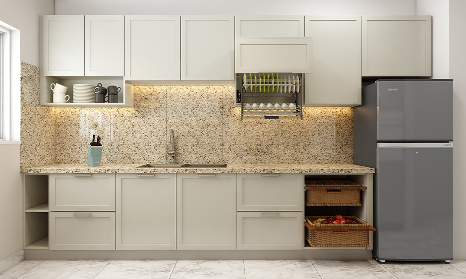 Minimalist kitchen with white shaker-style cabinets, open shelving, beige speckled countertop, and wicker basket for storage