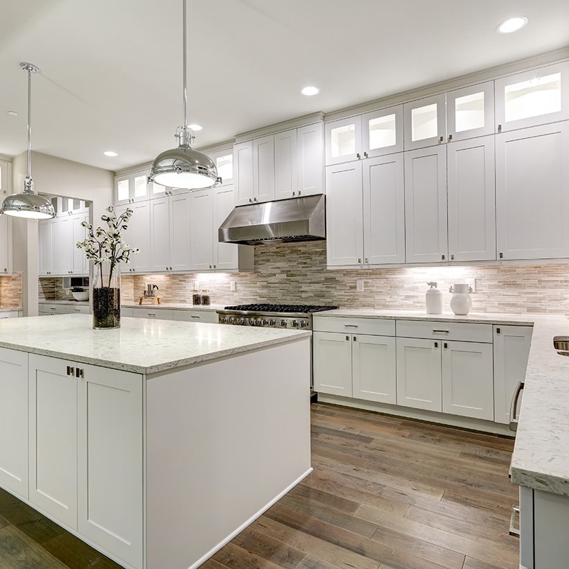 White kitchen island fits right into a white kitchen with stainless steel accents